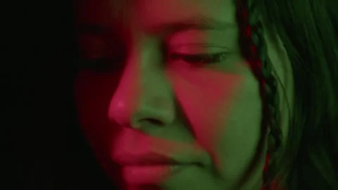Close-Up Portrait with Dramatic Lighting and Braided Hair Stock Footage 321203436