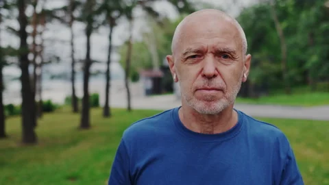 Close Up Portrait of Elder Handsome Man. He Walking and Looking in to the Camera Stock Footage 148317685