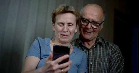 Close-up portrait of an elderly couple who are sitting at home in quarantine and Видео 129492669