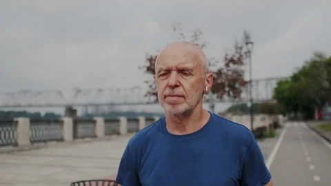 Close Up Portrait of Elderly Man while He Running or Jogging in Park. Rehab or Stock Footage 148317192