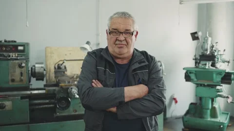 Close-up portrait of an elderly working pensioner locksmith turner in a lathe Stock Footage 284545792