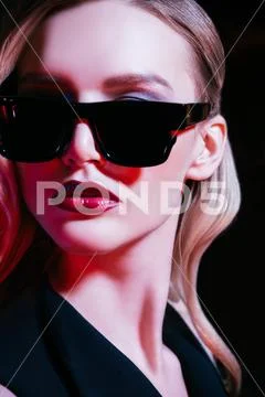 A close up portrait of an elegant lady wearing sunglasses. Beauty, make-up, s Stock Photos