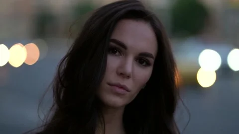 Close-up portrait of the face of a bright dark-haired girl, she poses against Stock Footage 138216792