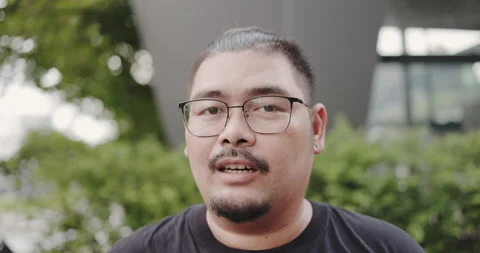 Close up portrait of face Charming obese Asian man talking positive thinking. Stock Footage 159351087