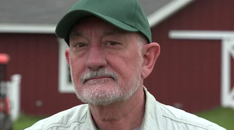Close up portrait of a farmer in front of his barn Stock Footage