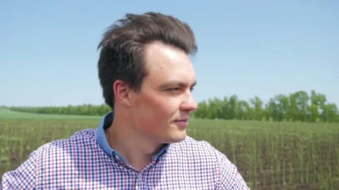 Close up portrait of farmer man looking to camera in asparagus field. Face of 動画素材 130404392