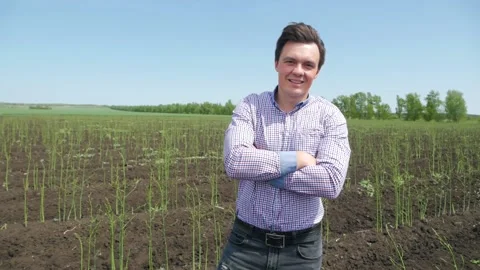 Close up portrait of farmer man looking to camera in asparagus field. Face of Stock Footage 143030623