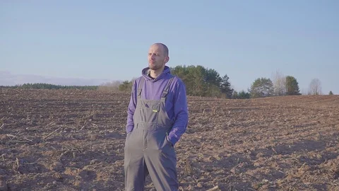 Close up portrait of farmer man standing in field and looking to the his Stock Footage 106394438