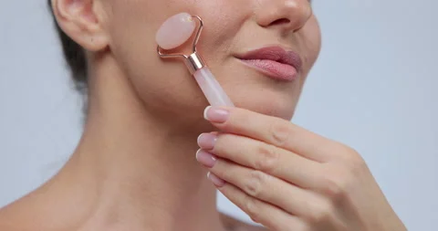 Close up portrait female using natural massager tool for skin care and spa Stock Footage 169692297
