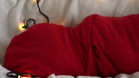 Close Up Portrait First Days Of Life Newborn Cute Funny Sleeping Baby In Santa Stock Footage 164526733