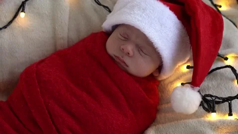 Close Up Portrait First Days Of Life Newborn Cute Funny Sleeping Baby In Santa Stock Footage 164954572