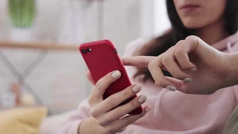 Close up Portrait focused girl tapping on sellphone. young female texting on Stock Footage