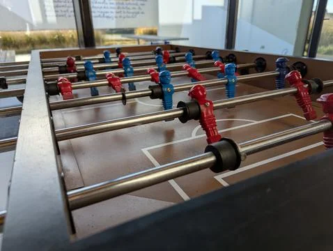 A close portrait of a foosball table at the level of the minature plastic s.. Photos