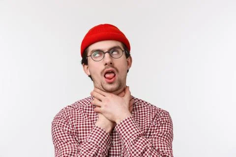 Close-up portrait of funny bearded guy chocking himself stick tongue as if cant Stock Photos