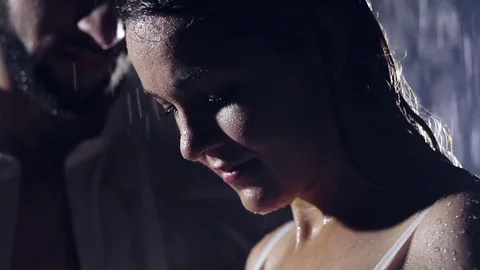 Close-up. portrait of a girl in the darkness under the shower, amid her beloved Stock Footage