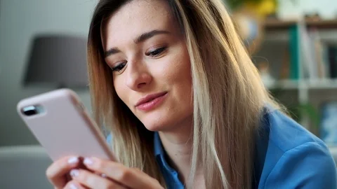 Close up portrait of girl using mobile device browsing the internet, staying Stock Footage 108789647