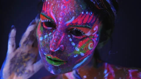 Close-up portrait of girl with a UV pattern on her face. Body art. Stock Footage 221434287