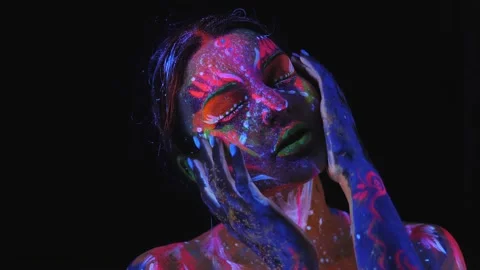 Close-up portrait of girl with a UV pattern on her face. Body art. Stock Footage 221620324