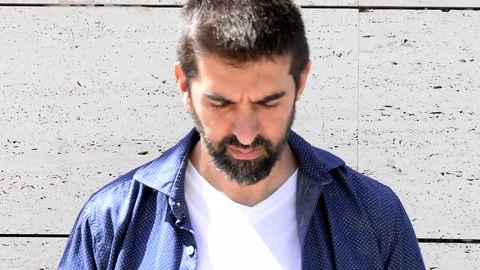 Close-up portrait of good-looking bearded guy in stylish clothing standing ou Stock Footage 135638360