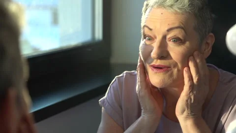 Close-up portrait of a gray-haired elderly woman,skin care and make up Stock Footage 170517019