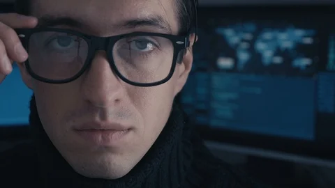 Close up Portrait Hacker programmer in glasses in dark cyber security center Stock Footage 100687473