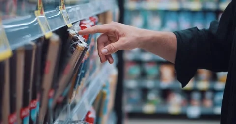 Close up portrait of hands of man client pick up products in supermarket Stock Footage 253548689