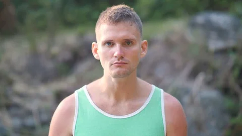 Close up portrait of a handsome athletic man wearing green sleeveless shirt. Stock Footage 124203177