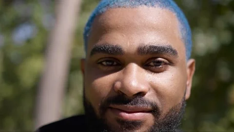 Close-up portrait of handsome black man with blue hair looking 스톡 동영상 287488795