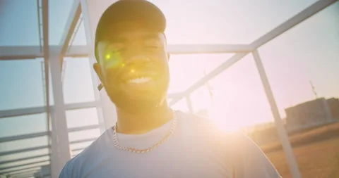 Close up portrait of handsome cheerful black young man smiling standing outdoors Stock Footage 140738853