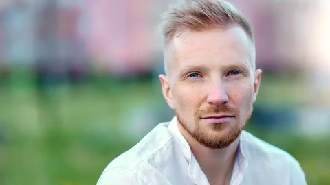 Close-up portrait of handsome confident young male posing pensively looking at Vidéo 113486776