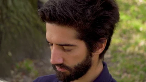 Close up portrait of handsome man with beard and black hair outdoor Video stock 105265202
