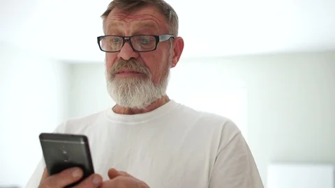 Close-up portrait of a handsome man with a mobile phone in his hands Stock Footage 120831223