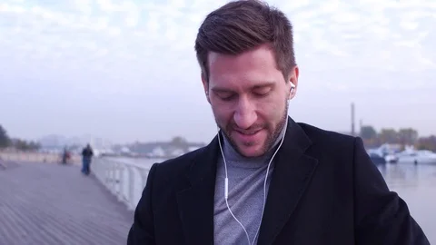 Close up portrait of a handsome young man smiling at embankment. Stock Footage 101125785