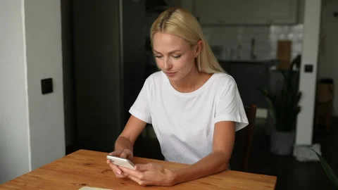Close-up portrait of happy amazed young woman getting good online news on Stock Footage 223923892