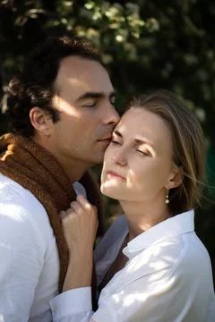 Close-up portrait of happy couple in the tree flowering, closeup, young wom.. Stock Photos