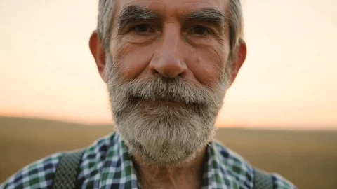 Close up portrait of happy fermer with beard smiling on camera in the golden Stock Footage 78815798