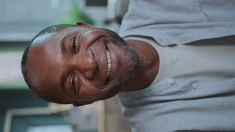 Close-up portrait of happy man smiling at camera. Blurred background of modern Stock Footage 238749064