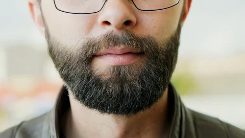 Close-up portrait of hungry bearded man eating ice cream Stock Footage 107826704