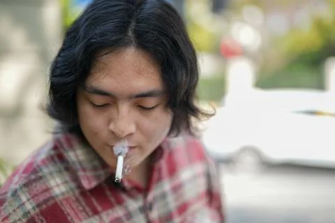 Close portrait with lit cigarette Stock Photos