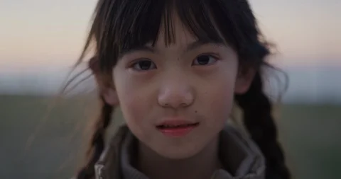 Close up portrait little asian girl smiling happy enjoying summer vacation on Stock Footage