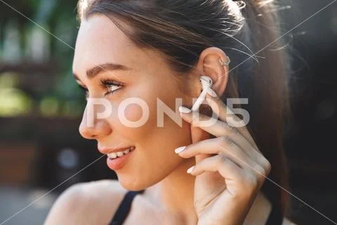 Close up portrait of a lovely young fitness girl listening Stock Photos