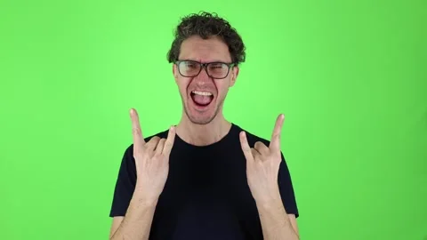 Close up portrait man actively shows sign, gesture of horn with hands. 動画素材 303143624