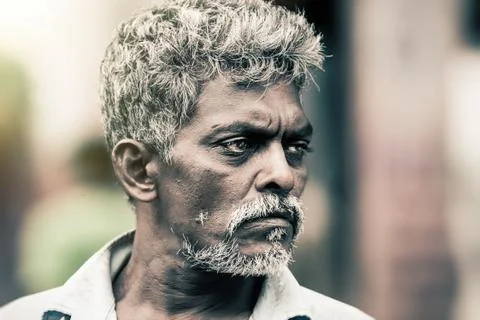 Close portrait of a man with dark complexion and white hair. Kandy, Sri Lanka Stock Photos