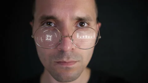 Close-up of a portrait of a man. The glasses display Futuristic graphics. New te Video stock 156083586