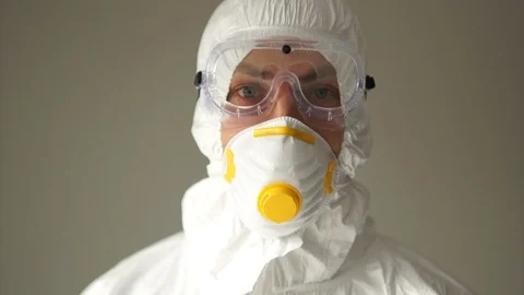 Close portrait of a man in a protective suit and blue gloves shows a thumbs up Stock Footage 126506583