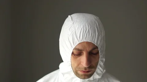 Close portrait of a man in a protective suit wears a mask respirator. Medical Stock Footage 126507214