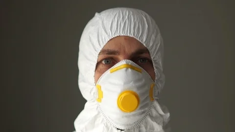 Close portrait of a man in a protective suit wears plastic safety glasses Stock Footage 126507973
