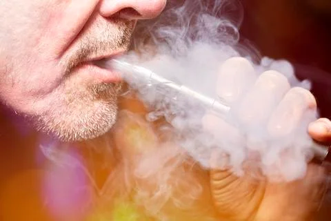 Close up portrait of a man smoking an e-cigarette Stock Photos