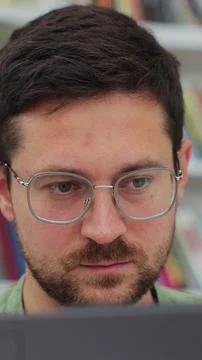Close up portrait man student preparing exam and learning lessons in librar.. Stock Photos