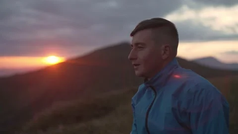 Close-up portrait of a man at sunset in the mountains. Stock Footage 218438745